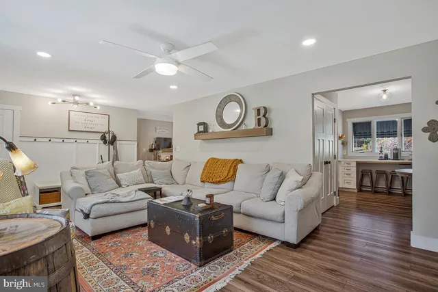 a living room with furniture and wooden floor