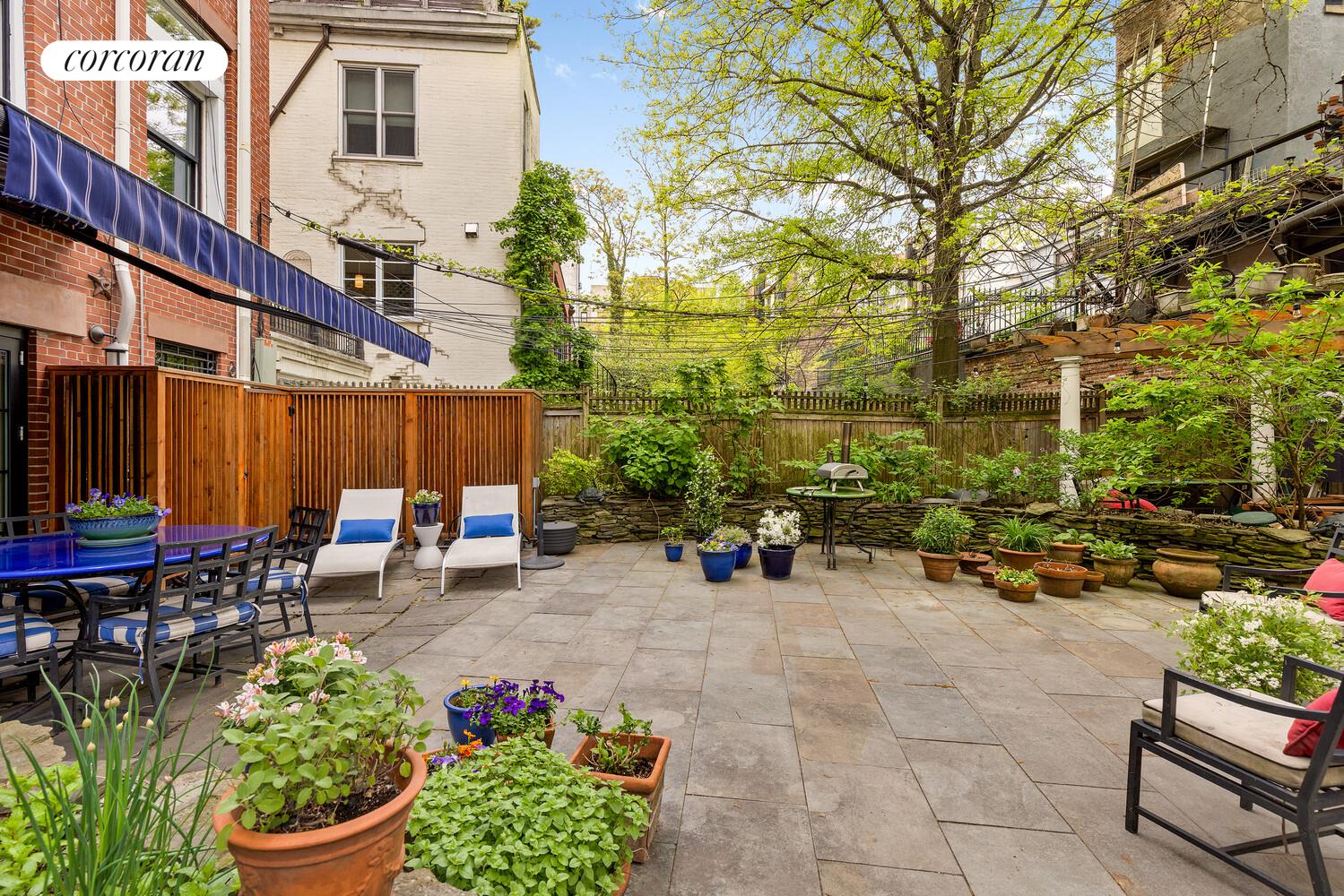 122 State Street Brooklyn, NY 11201 - Photo 10 of 26 a view of a patio with table and chairs potted plants and a large tree