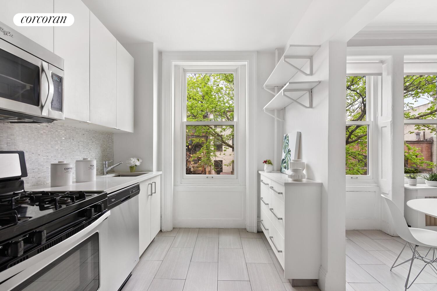 122 State Street Brooklyn, NY 11201 - Photo 16 of 26 a kitchen with stainless steel appliances a stove a sink and a white cabinets