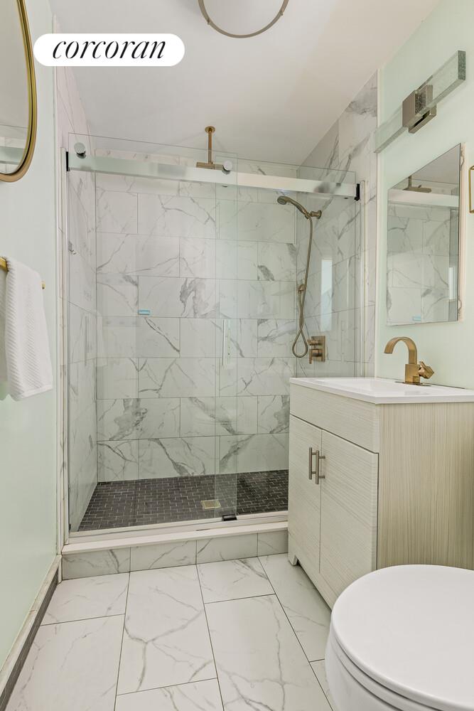 122 State Street Brooklyn, NY 11201 - Photo 25 of 26 a bathroom with a sink a toilet and shower