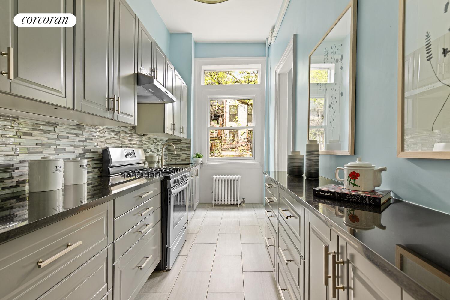 122 State Street Brooklyn, NY 11201 - Photo 5 of 26 a kitchen with stainless steel appliances granite countertop a sink stove and cabinets