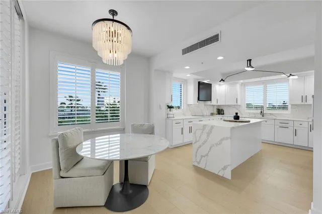 a view of kitchen with sink dining table and chairs