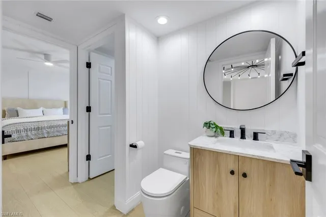 a bathroom with a toilet a sink and a mirror