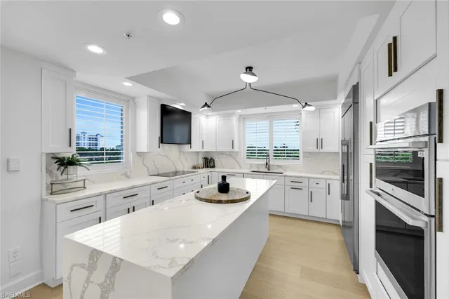 a kitchen with sink a stove and cabinets