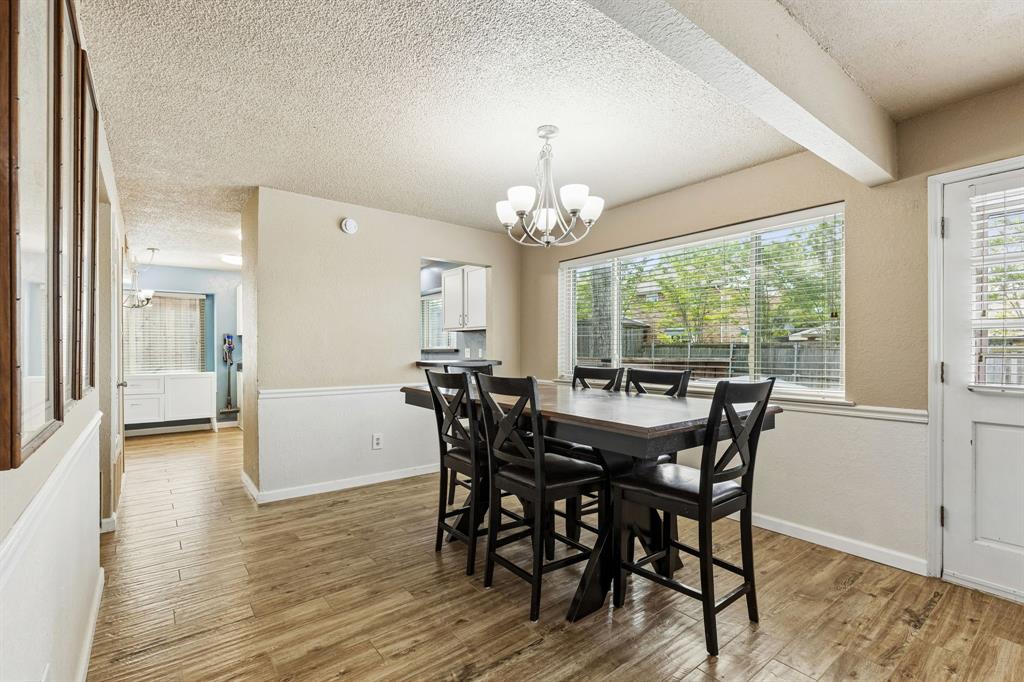304 Lark Lane Euless, TX 76039 - Photo 5 of 32 a view of a dining room with furniture window and wooden floor