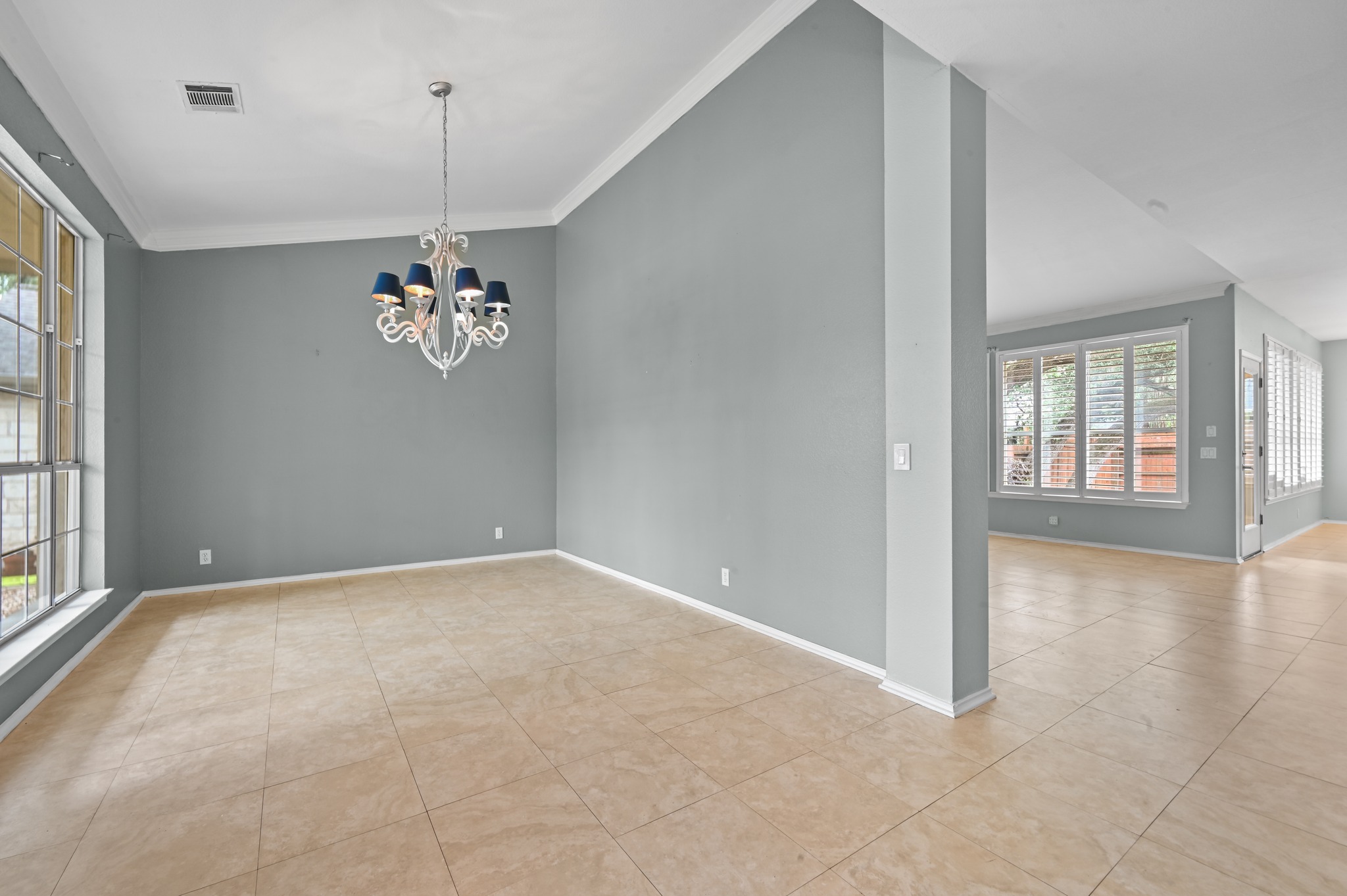 5313 Moon Shadow Drive Austin, TX 78735 - Photo 5 of 30 Interior room featuring tile flooring, a decorative chandelier, and crown molding