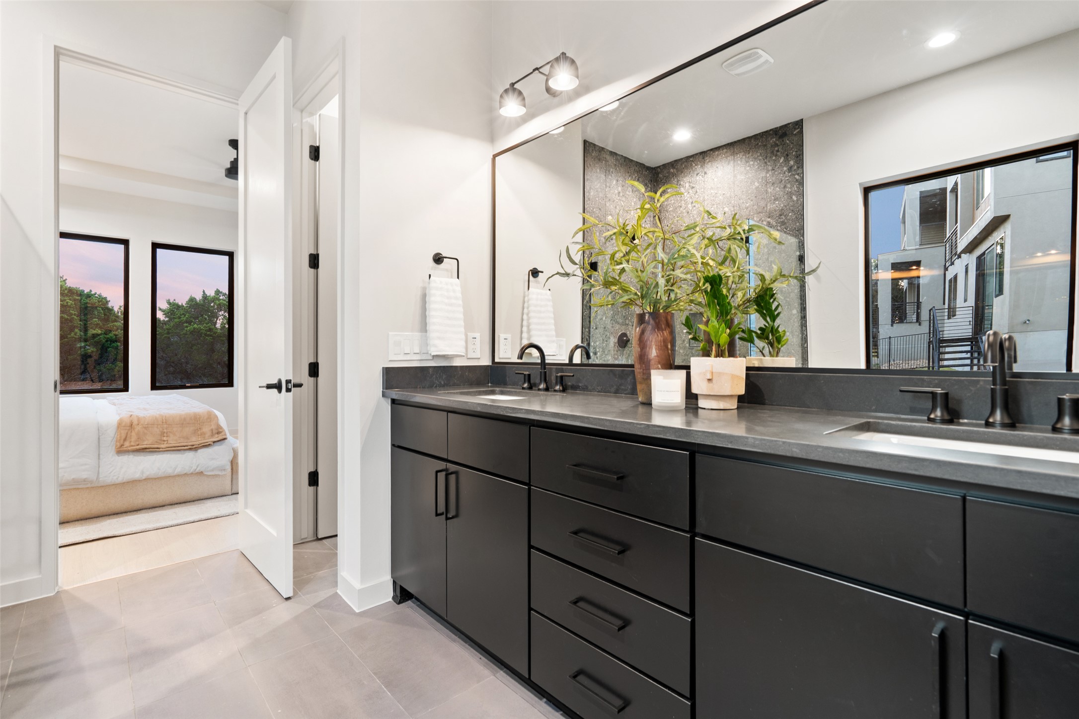 9803 Ribelin Ranch Court Austin, TX 78750 - Photo 18 of 34 A chic primary bathroom vanity with dual sinks, modern cabinetry, and sleek hardware awaits.