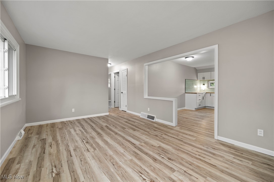 6265 Jaycox Road North Ridgeville, OH 44039 - Photo 7 of 39 Unfurnished living room featuring light wood-type flooring and baseboards