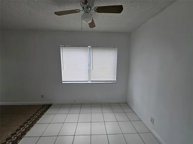 an empty room with a empty space and windows