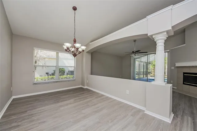 a view of a room with window wooden floor and a chandelier