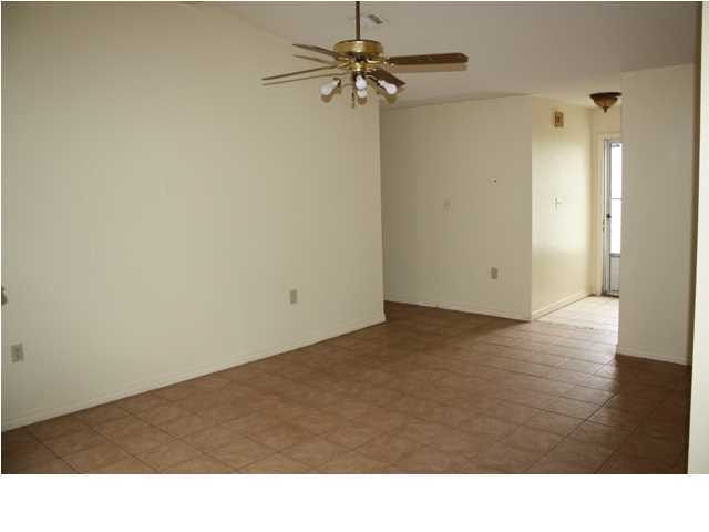 41 3rd Avenue Shalimar, FL 32579 - Photo 4 of 9 a room with wooden floor and a ceiling fan