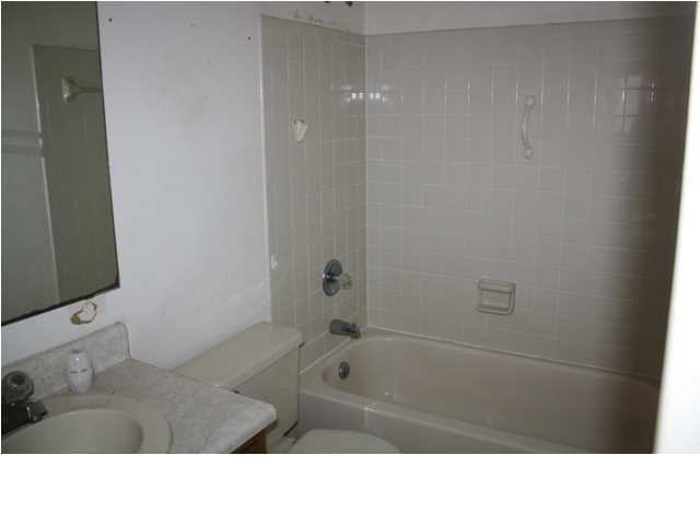 41 3rd Avenue Shalimar, FL 32579 - Photo 7 of 9 a bathroom with a tub sink vanity and mirror