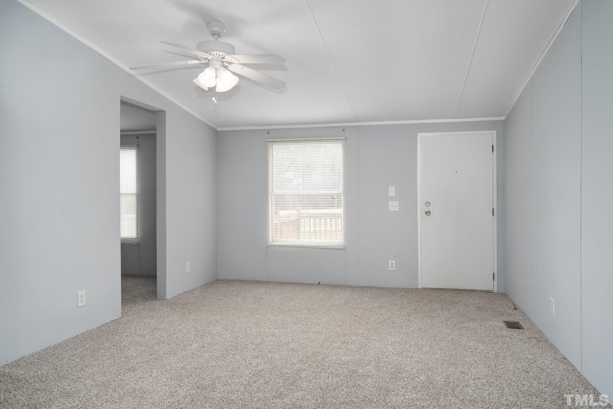 10014 Lake Royale Rd Spring Spring Hope, NC 27882 - Photo 6 of 26 an empty room with windows and ceiling fan
