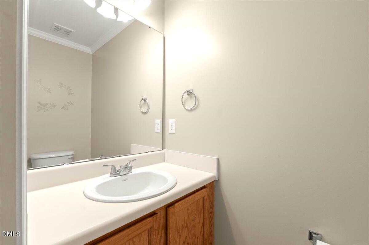 2621 Hamlet Green Drive Raleigh, NC 27614 - Photo 13 of 20 a bathroom with a granite countertop sink and a mirror