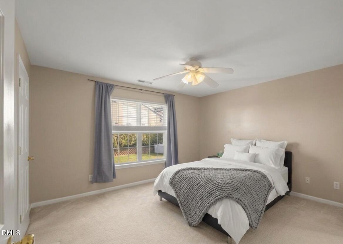 2621 Hamlet Green Drive Raleigh, NC 27614 - Photo 14 of 20 a bedroom with a bed and a window
