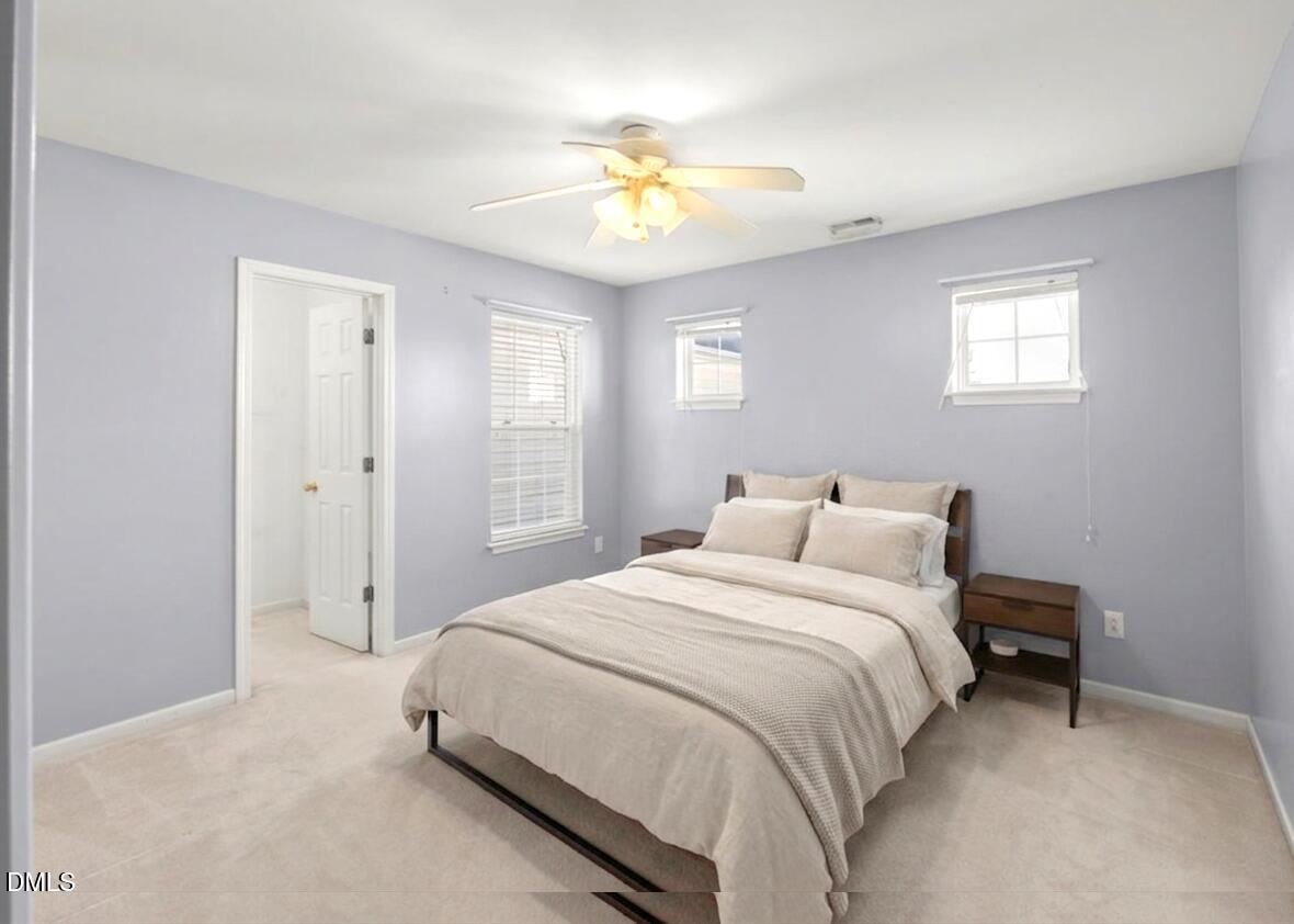 2621 Hamlet Green Drive Raleigh, NC 27614 - Photo 16 of 20 a bedroom with a bed and a chandelier