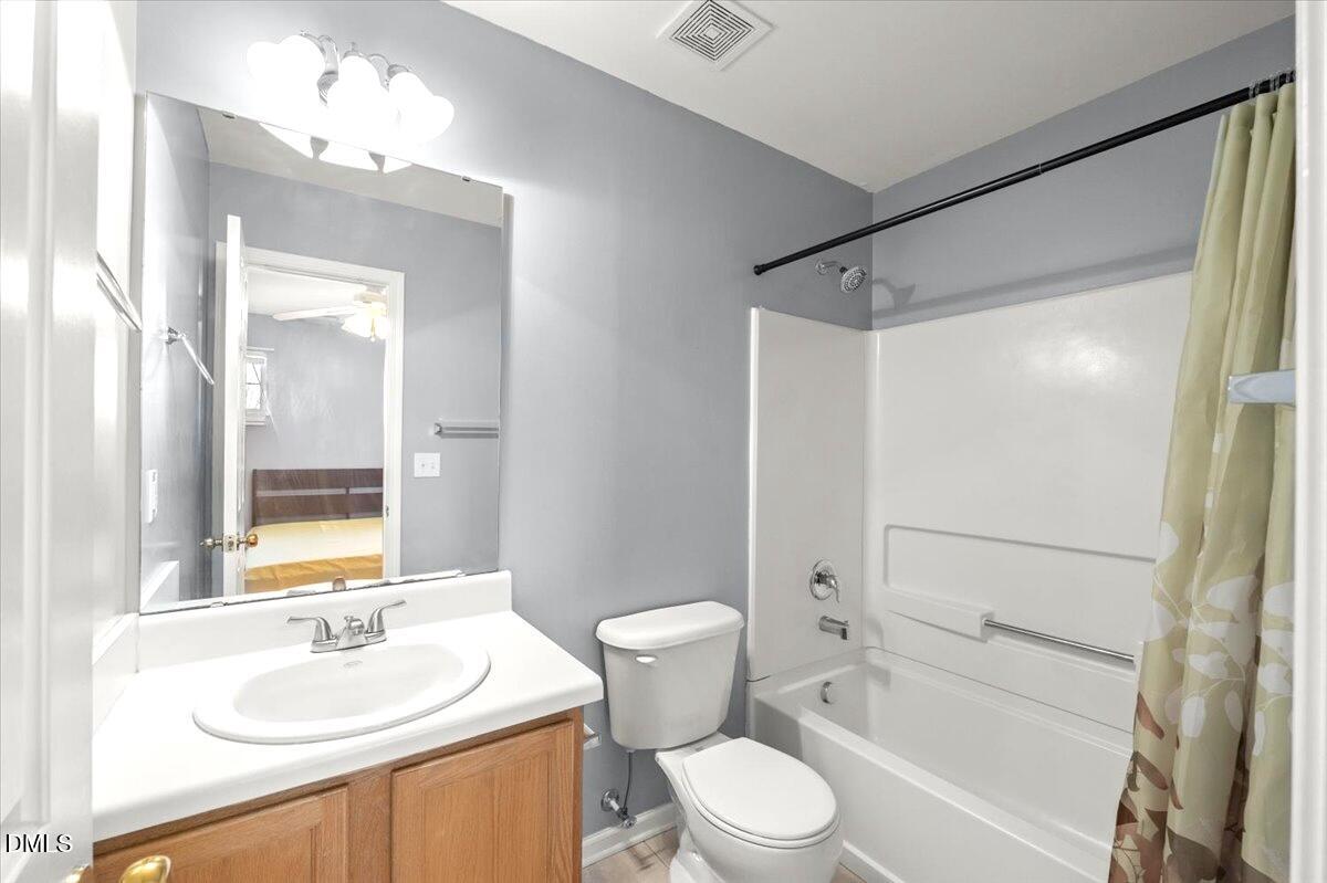 2621 Hamlet Green Drive Raleigh, NC 27614 - Photo 17 of 20 a bathroom with a sink a toilet and shower