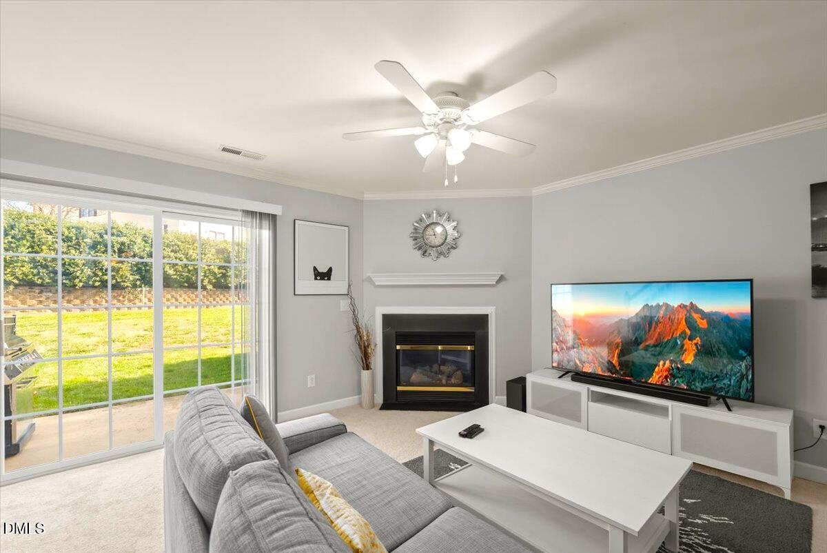 2621 Hamlet Green Drive Raleigh, NC 27614 - Photo 6 of 20 a living room with furniture a flat screen tv and a fireplace