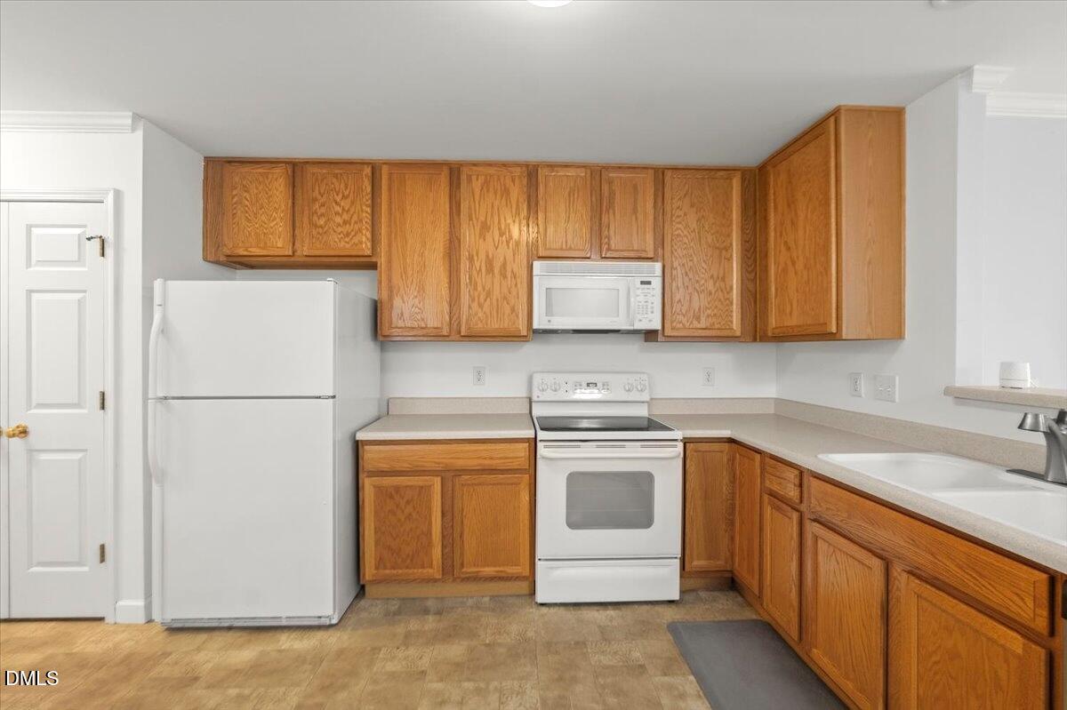 2621 Hamlet Green Drive Raleigh, NC 27614 - Photo 10 of 20 a kitchen with stainless steel appliances granite countertop a sink stove and microwave