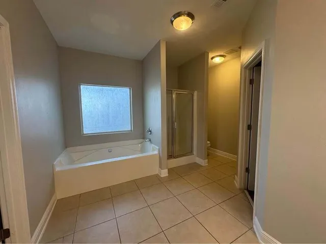 a bathroom with a bathtub and a shower