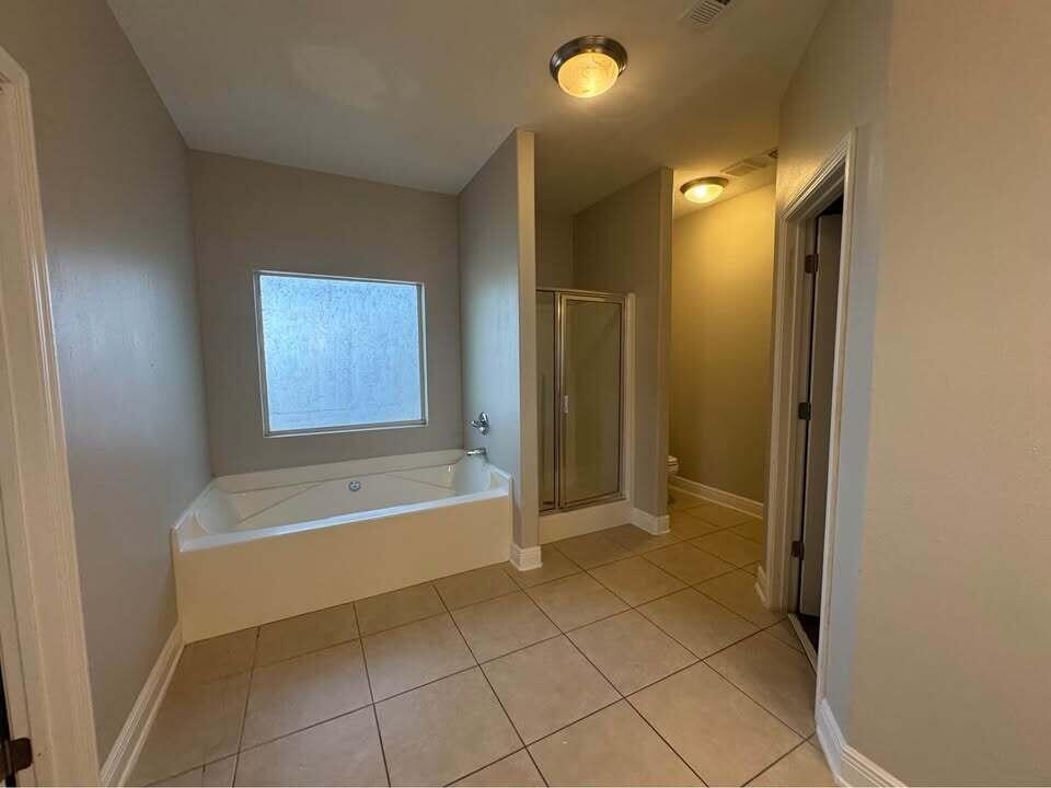 371 Symphony Way Freeport, FL 32439 - Photo 12 of 26 a bathroom with a bathtub and a shower
