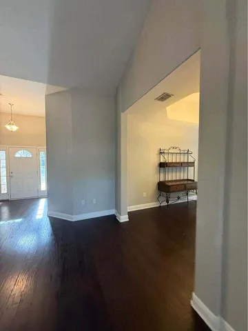 a view of a room with wooden floor and windows