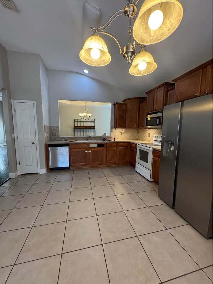 371 Symphony Way Freeport, FL 32439 - Photo 16 of 26 a kitchen with stainless steel appliances granite countertop a stove a sink dishwasher and a refrigerator