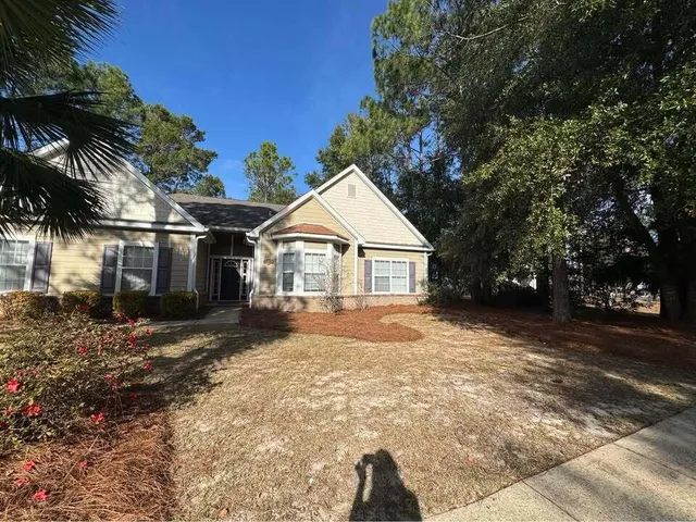 a view of a white house with a yard