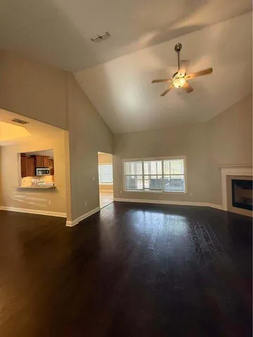 a view of a livingroom with a ceiling fan and window
