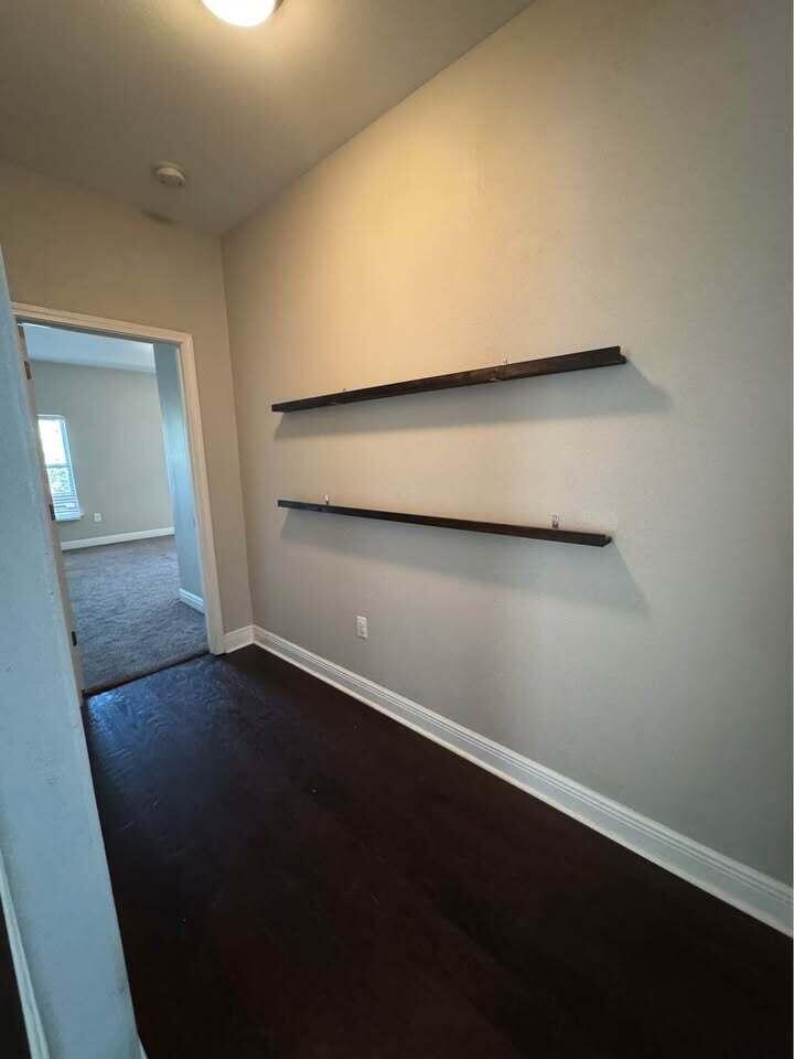 371 Symphony Way Freeport, FL 32439 - Photo 2 of 26 an empty room with wooden floor and door