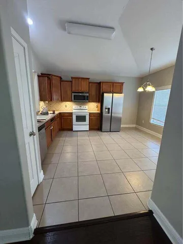 a kitchen with a sink a counter space and appliances