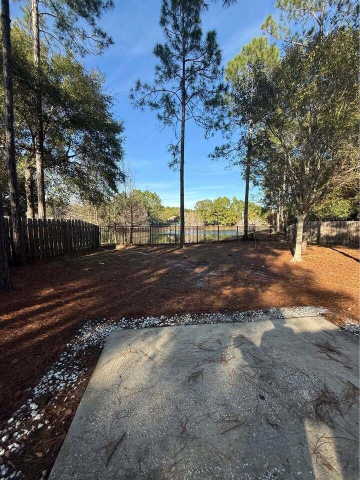 371 Symphony Way Freeport, FL 32439 - Photo 24 of 26 a view of a yard with wooden fence
