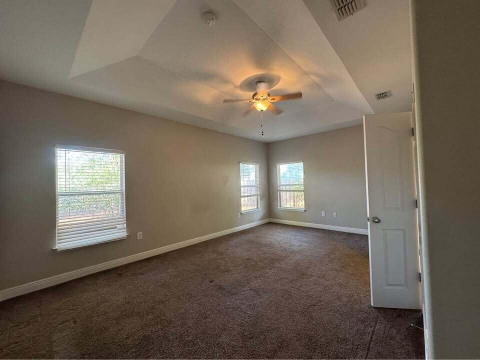 371 Symphony Way Freeport, FL 32439 - Photo 3 of 26 an empty room with a chandelier fan and windows
