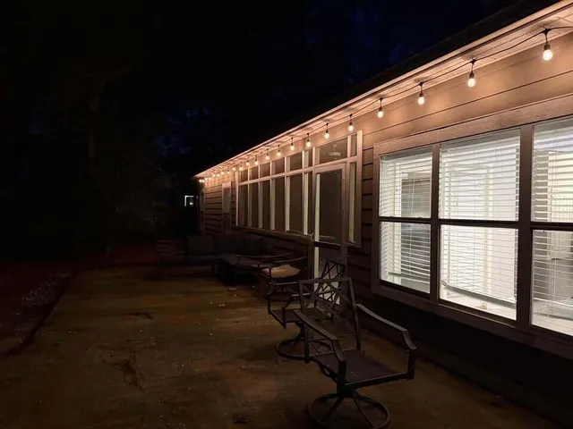 a backyard of a house with table and chairs