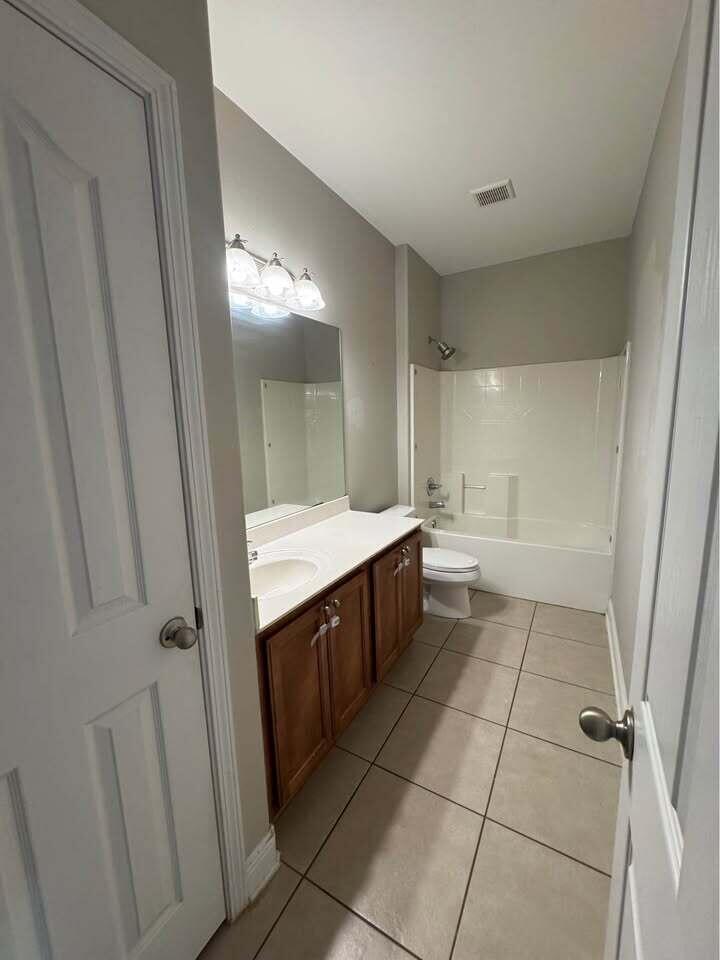 371 Symphony Way Freeport, FL 32439 - Photo 10 of 26 a large bathroom with a double vanity sink and a mirror