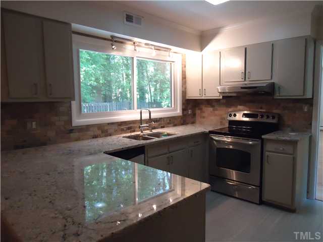 1533 Shadowood Lane Raleigh, NC 27612 - Photo 6 of 21 UPDATED KITCHEN WITH GRANITE AND PERIOD FEATURES. NEW 12X24 TILE. SMOOTH CEILINGS SLATE BACK SPLASH