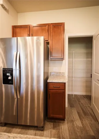 a kitchen with granite countertop sink cabinets and stainless steel appliances