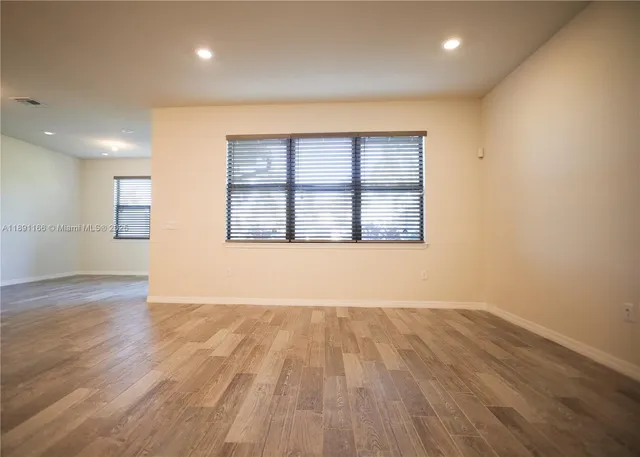 a view of a house with many windows and plants