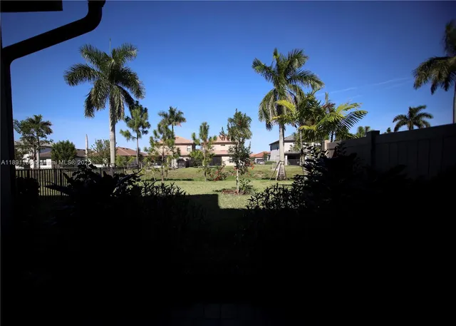 a view of a house with brick walls and flower plants