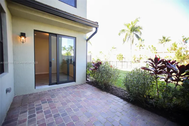 an empty room with painting on the wall and a window