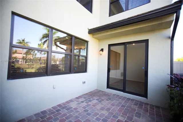 a spacious bathroom with a double vanity sink a mirror and a shower