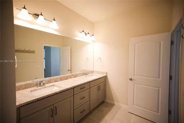 a bathroom with a sink vanity and mirror