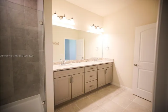 an empty room with window and ceiling fan