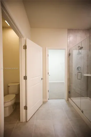 an empty room with a ceiling fan and a window