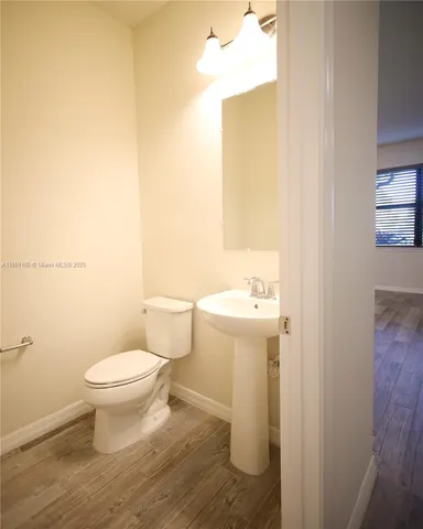 a white toilet sitting next to a bathroom sink