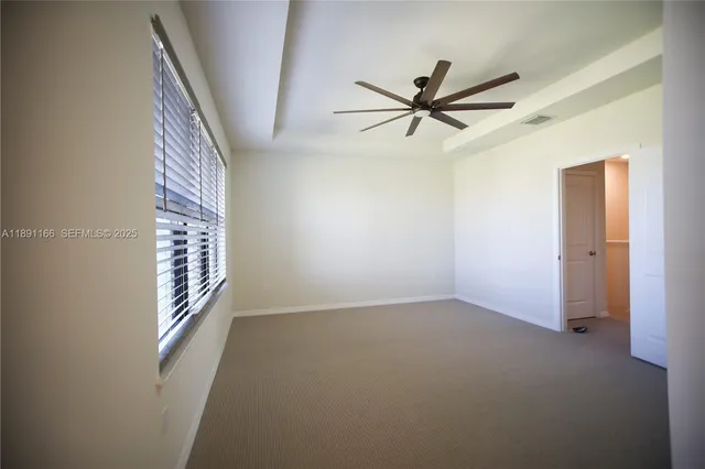 a view of hallway with stairs and a closet