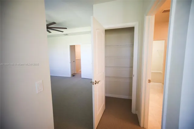 a view of hallway with stairs and a closet