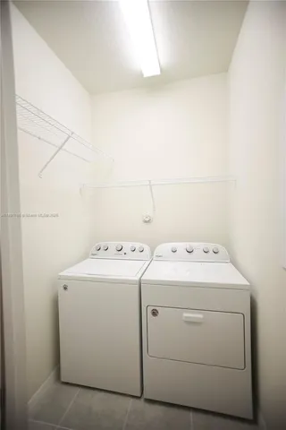 a dining room with wooden floor a chandelier a glass table and chairs