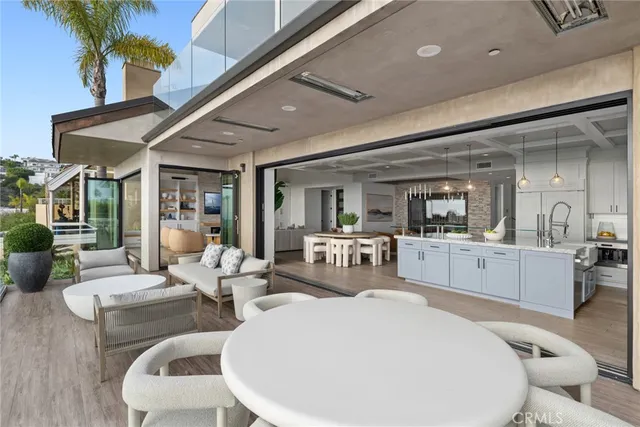 a kitchen with a sink a counter top space and living room view