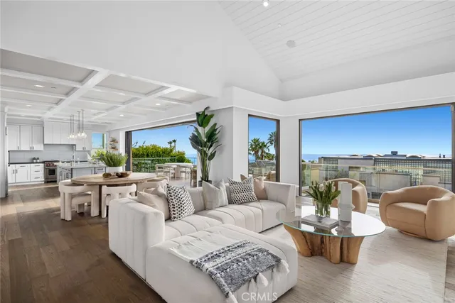 a living room with furniture and a view of kitchen